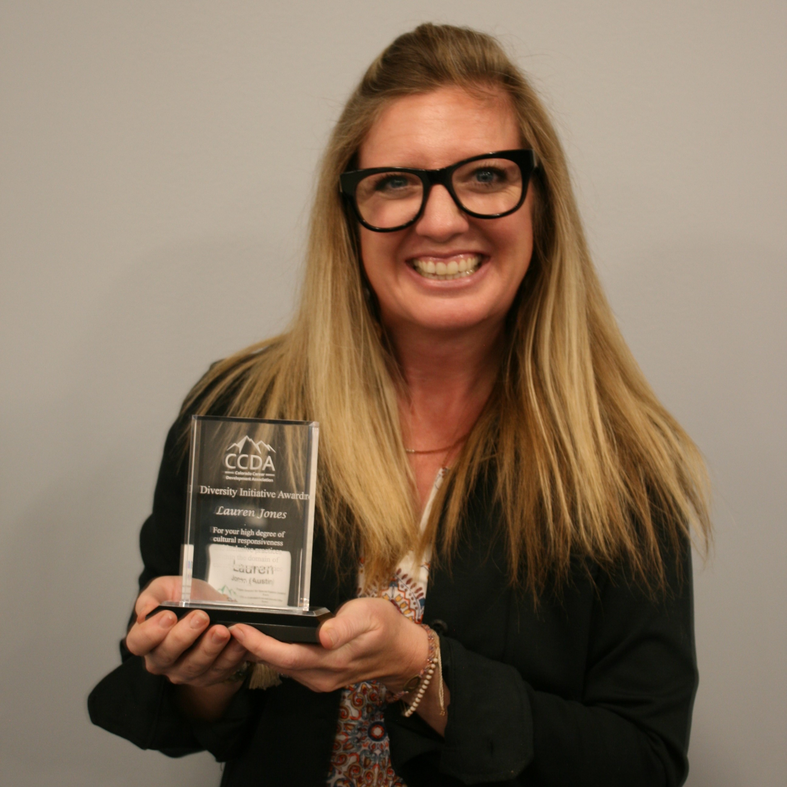 Lauren K Jones holds her Diversity Initiative award.